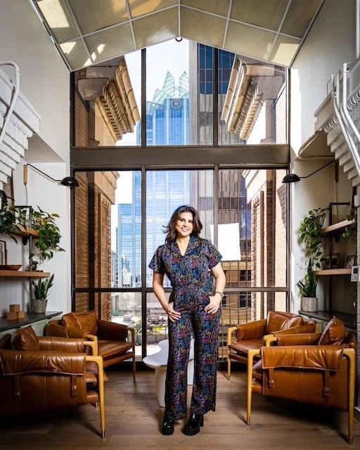 CEO of Disrupt PR stands infront of a window.