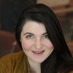 A confident individual with dark hair smiles at the camera, embodying Austin Public Relations expertise in social media and crisis management.