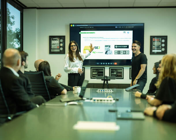 A group watches a presentation on Austin PR management, with leaders discussing social media strategy and crisis consulting.