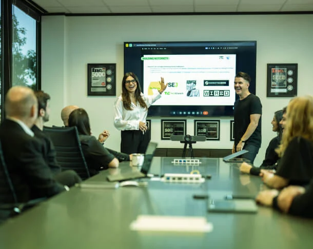 A group watches a presentation on Austin PR management, with leaders discussing social media strategy and crisis consulting.