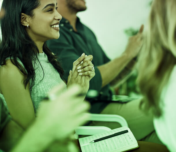 Participants in a row clapping at an Austin PR event on thought leadership, with focus on consulting and crisis management strategies.