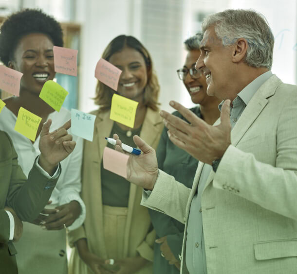 A group of PR professionals in Austin engage in dynamic discussions on crisis management and social media, surrounded by sticky notes.
