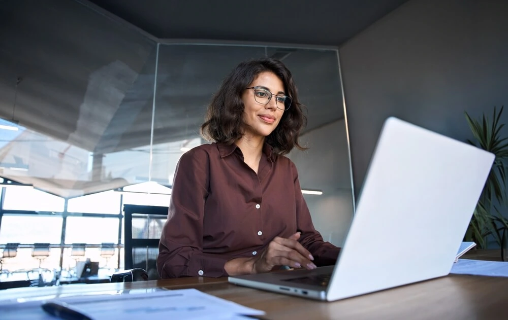 Woman looking up public relations on her laptop