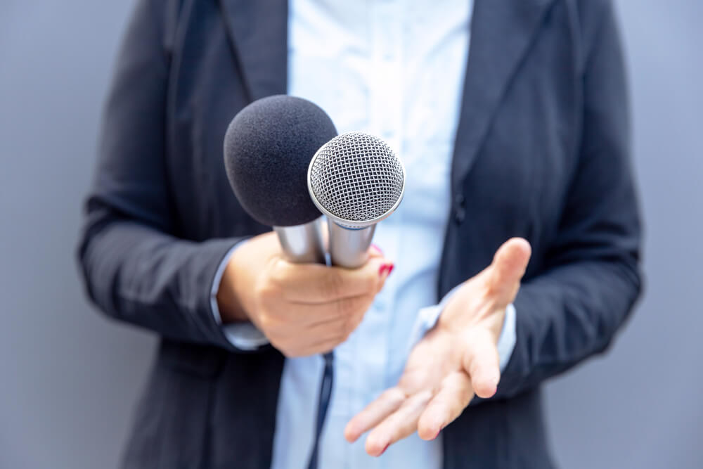 A woman holding a microphone.