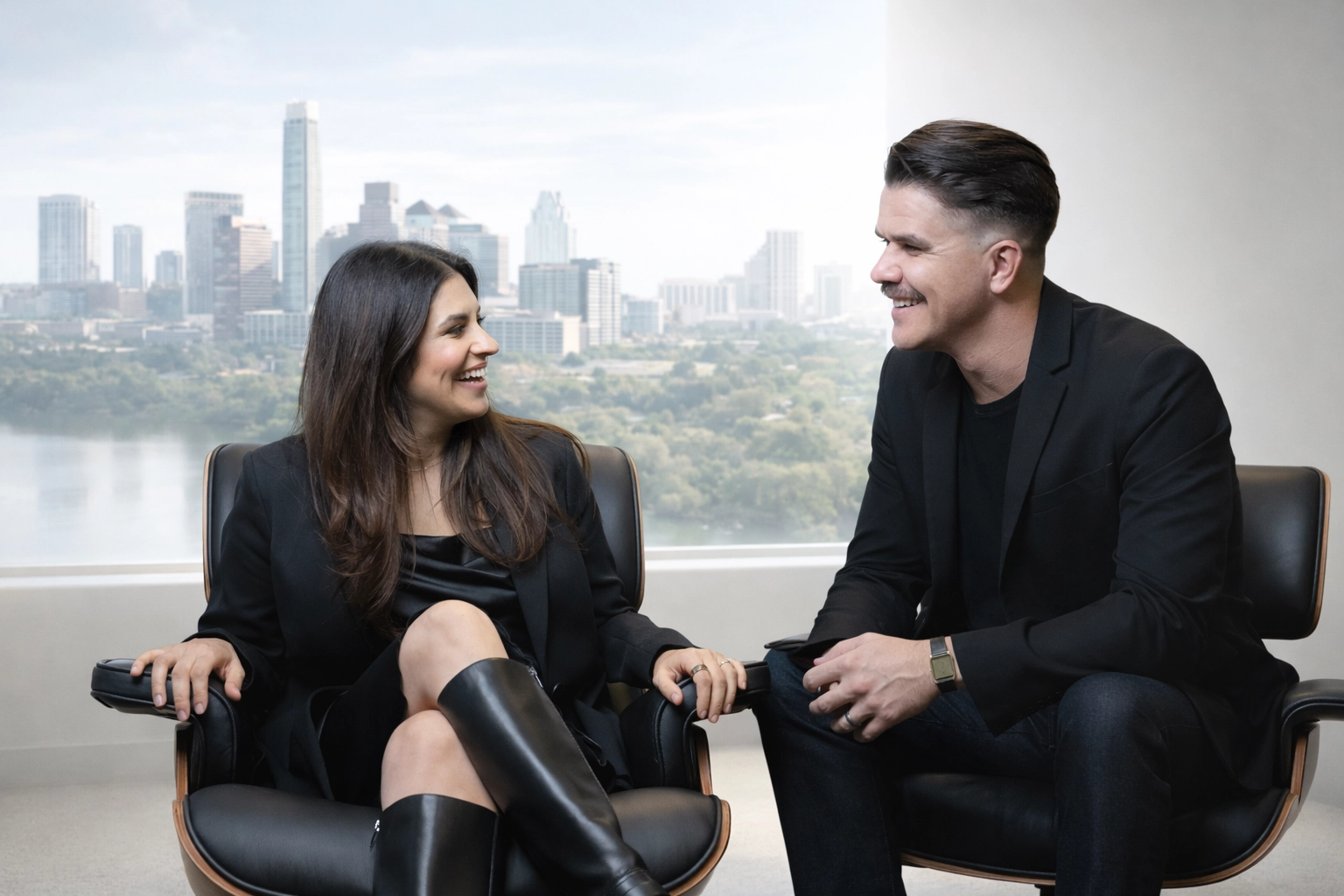 Two professionals in modern chairs discuss Austin Public Relations, Social Media, and Crisis Management with skyline view.